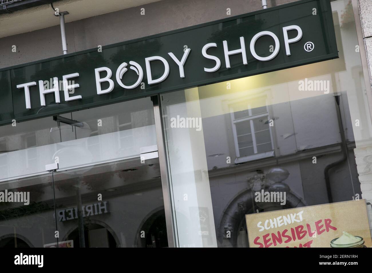 A logo sign outside of a The Body Shop retail store in Munich, Germany