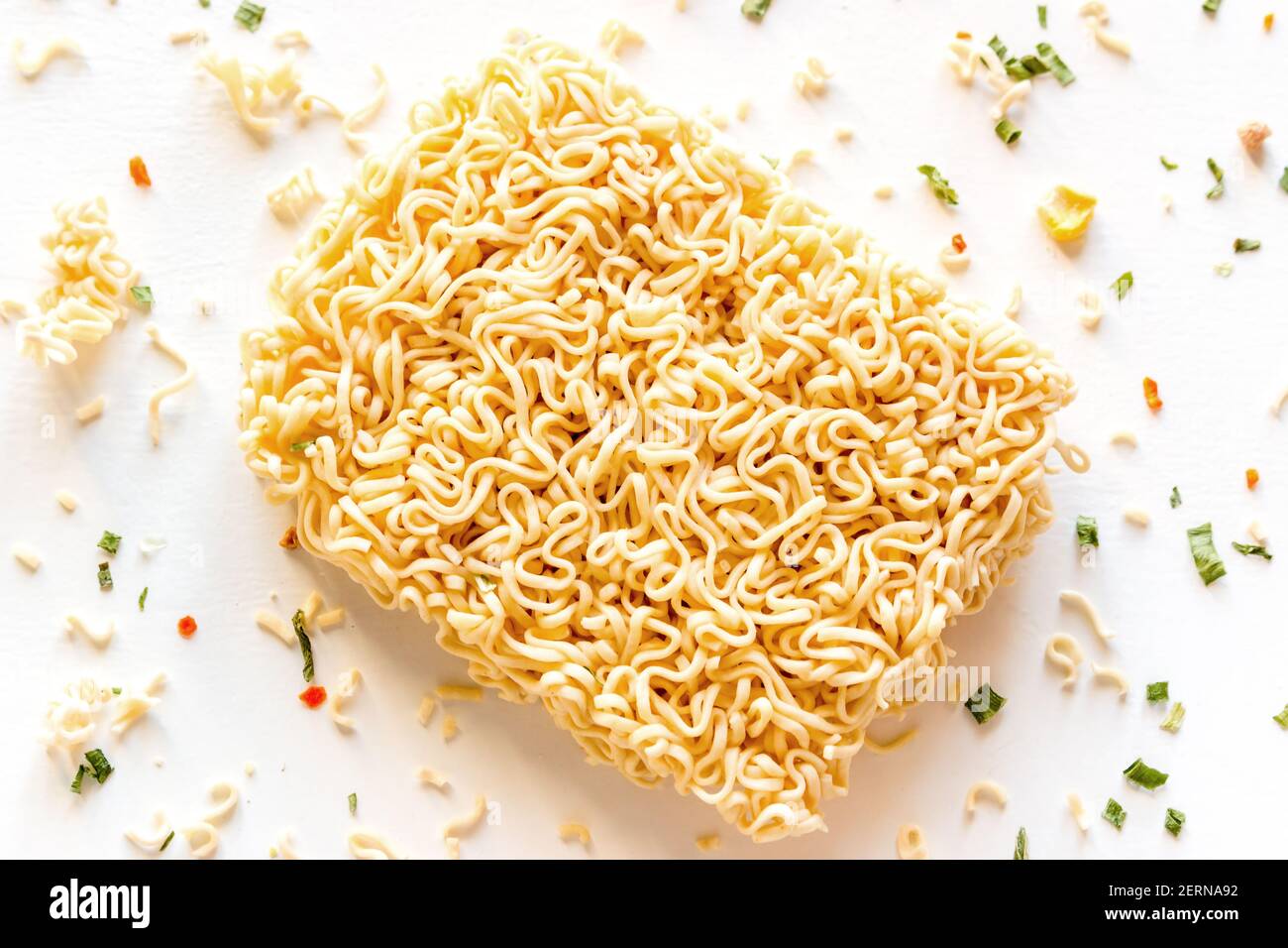 dry instant noodles with seasonings on a white background closeup