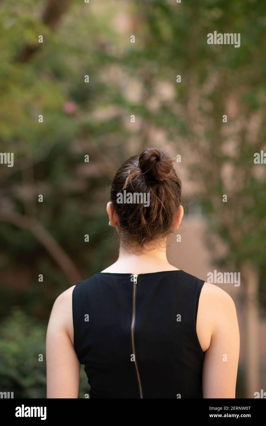 Woman back view standing bun alone hi-res stock photography and images ...