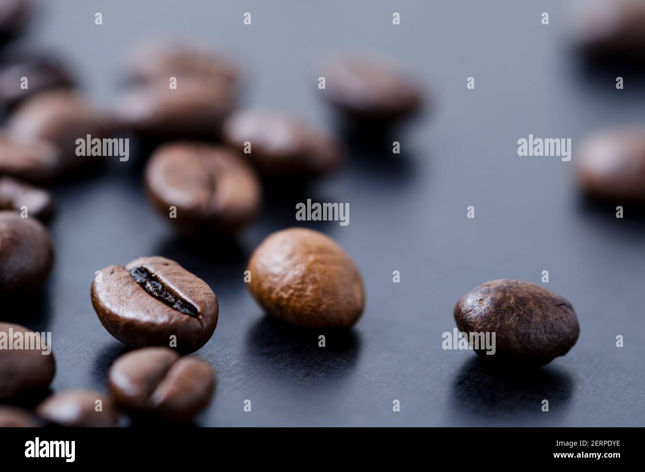 Loose roasted espresso coffee beans on dark background, close-up, flat lay view from above, still life, I love coffee concept Stock Photo