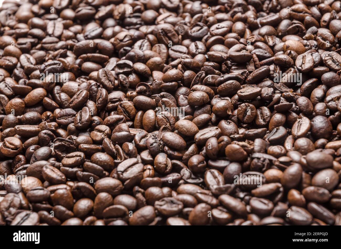 Roasted dark espresso coffee beans, full frame wallpaper background, close-up, flat lay view from above, still life, I love coffee concept Stock Photo
