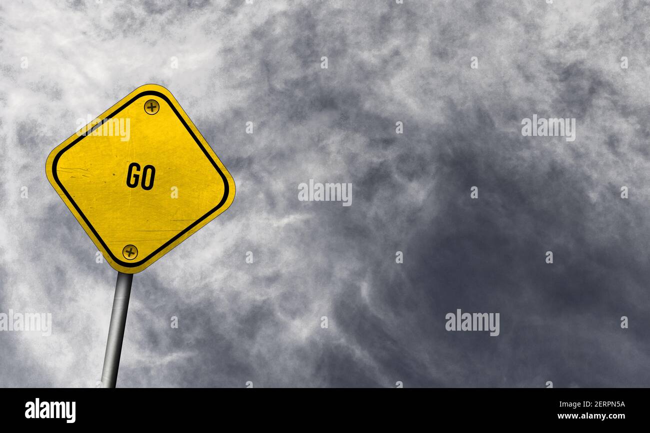 Go Yellow Signage go - yellow sign with cloudy background Stock Photo - Alamy