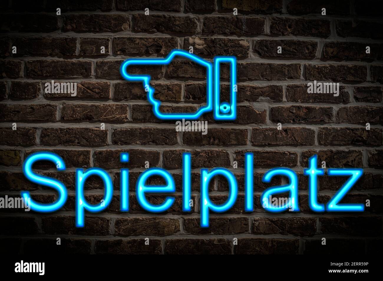 Detail photo of a neon sign on a wall with the inscription Spielplatz (Playground) Stock Photo