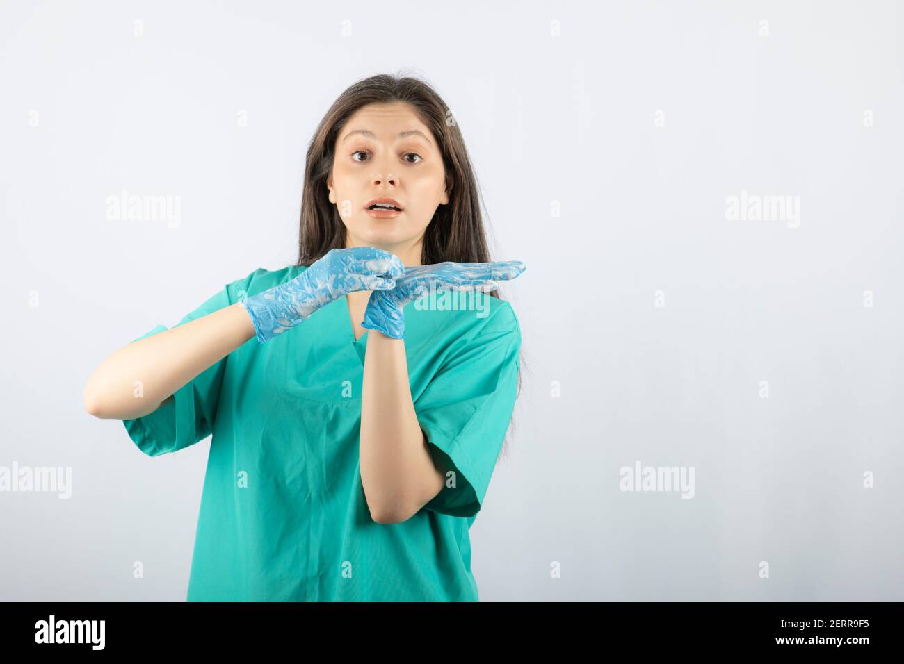 Portrait of a young nurse or doctor in green uniform posing Stock Photo