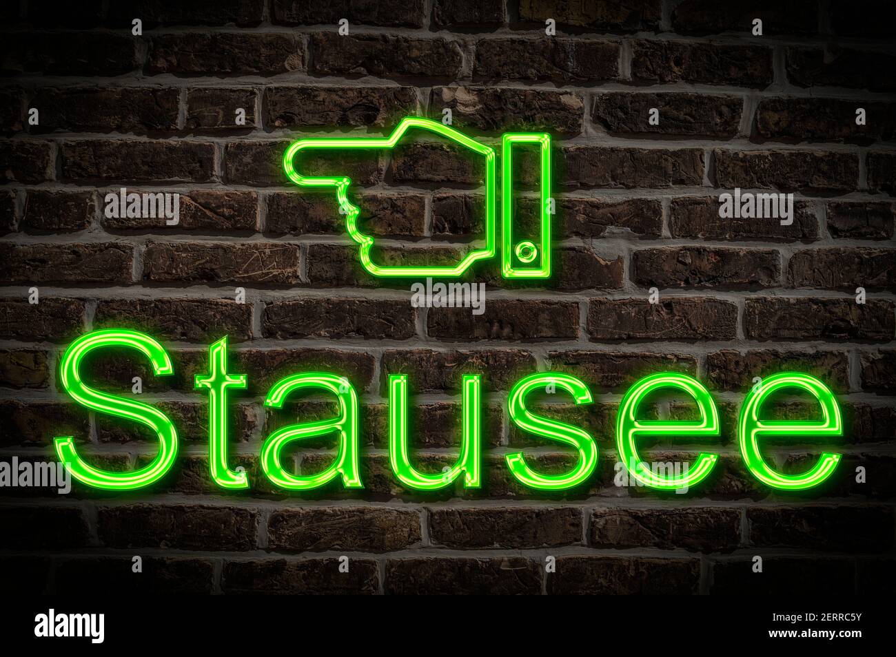Detail photo of a neon sign on a wall with the inscription Stausee (Reservoir) Stock Photo