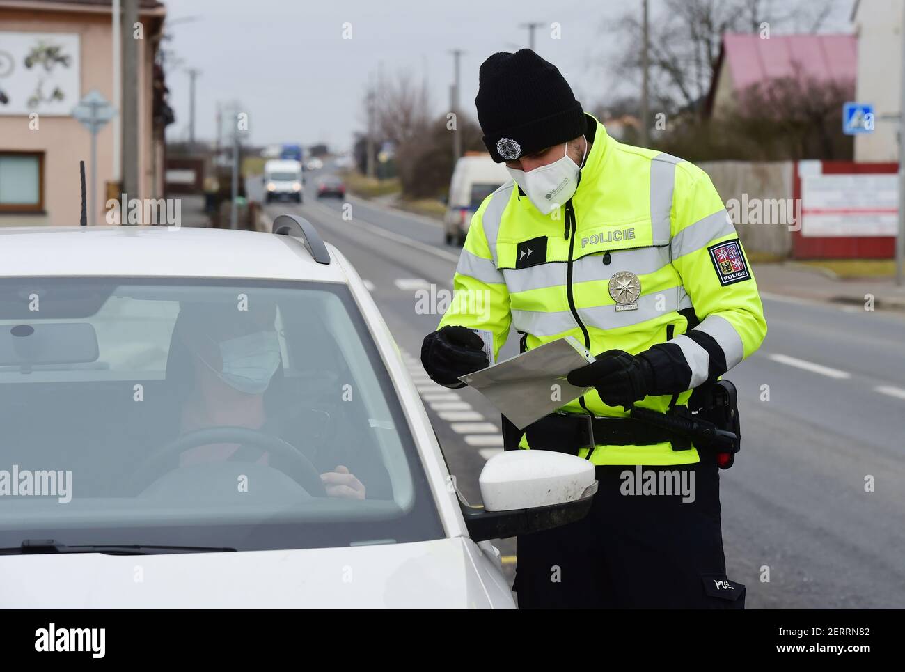Kokory, Czech Republic. 01st Mar, 2021. A total of 3,834 soldiers and 270 customs officers will help police check the observance of the new anti-epidemic restrictions in Czechia as of Tuesday, while altogether 30,000 will be deployed for this purpose. Pictured police control on road in Kokory, Czech Republic, March 1, 2021. Credit: Ludek Perina/CTK Photo/Alamy Live News Stock Photo