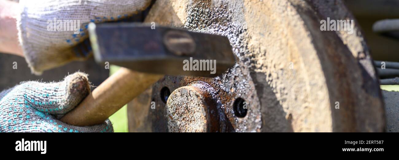 men's gloved hands repair of car drum brake himself. disassembles a
