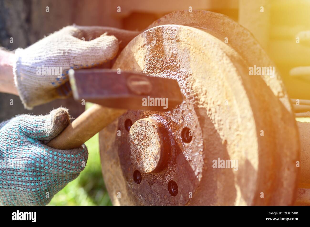 men's gloved hands repair of car drum brake himself. disassembles a