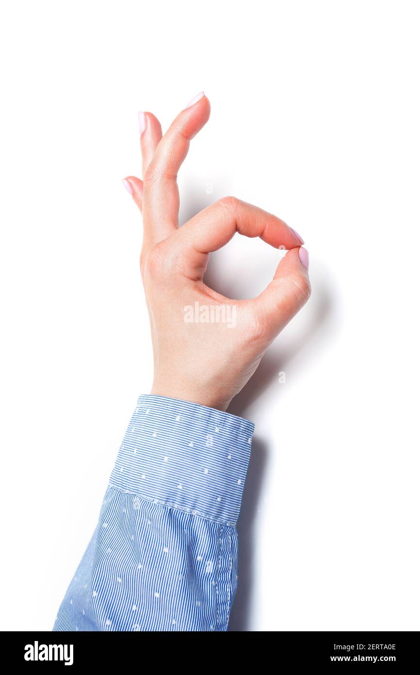 Female hand makes ok sign isolated on white. High quality photo Stock Photo