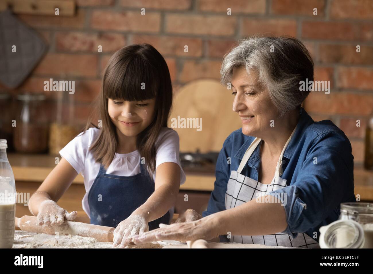 Senior grandmother and little granddaughter cooking together Stock ...