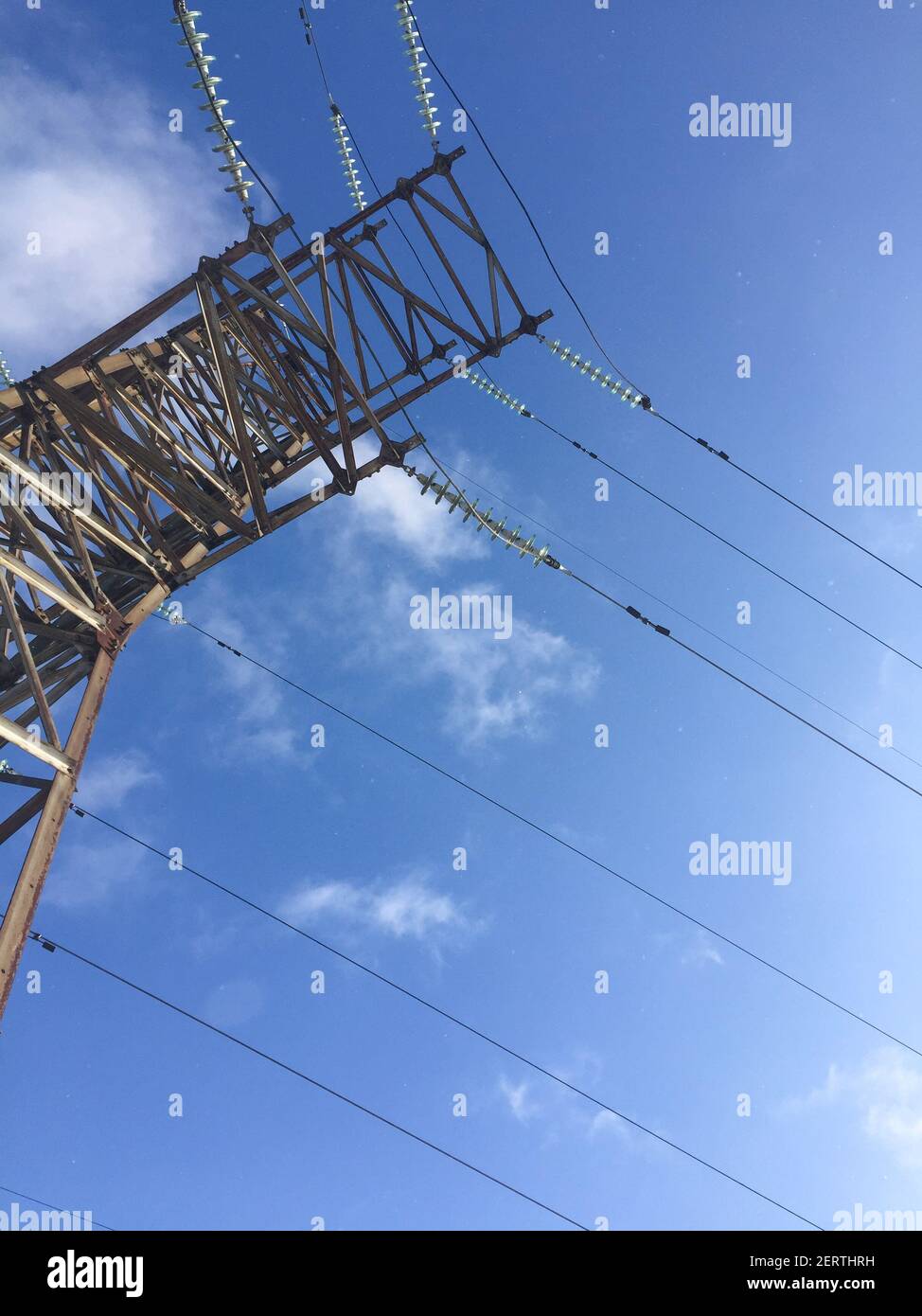 power line against a blue sky. high voltage tower. bottom-up view Stock ...