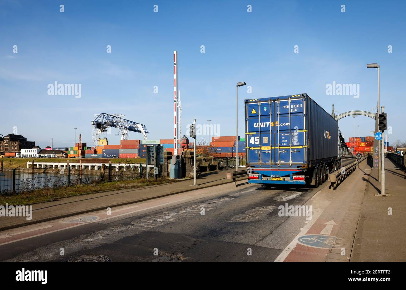 Krefeld, North Rhine-Westphalia, Germany - The Rhine Port of Krefeld is the fourth largest port in NRW, container trucks travel over the historic swin Stock Photo