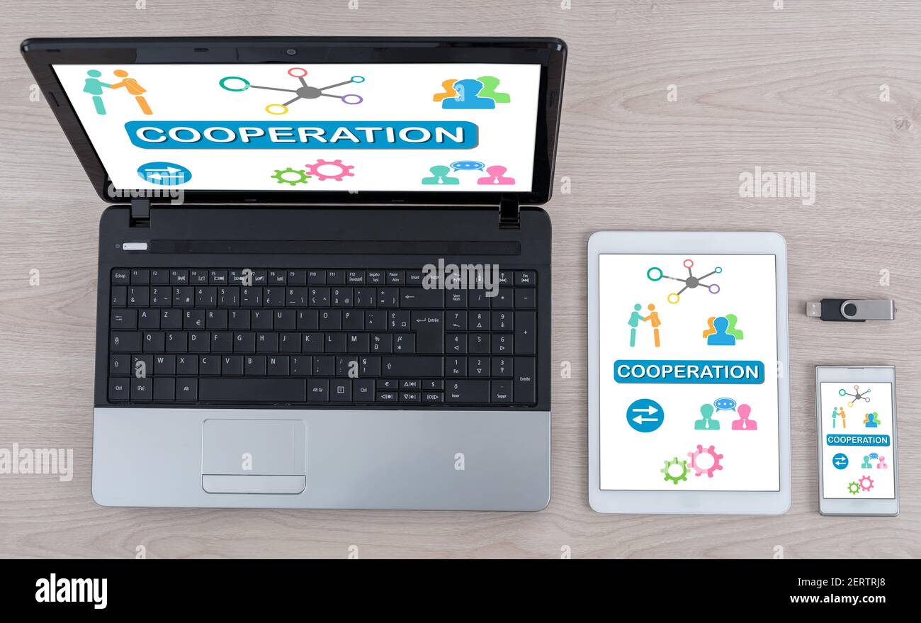 Cooperation concept shown on different information technology devices Stock Photo
