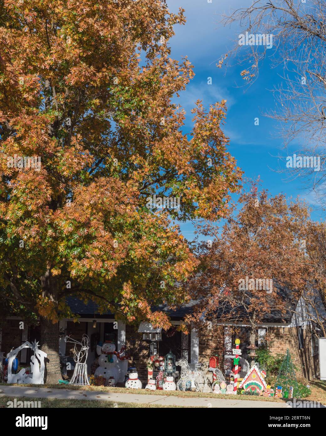 Residential street with outdoor Christmas decoration at front yard of