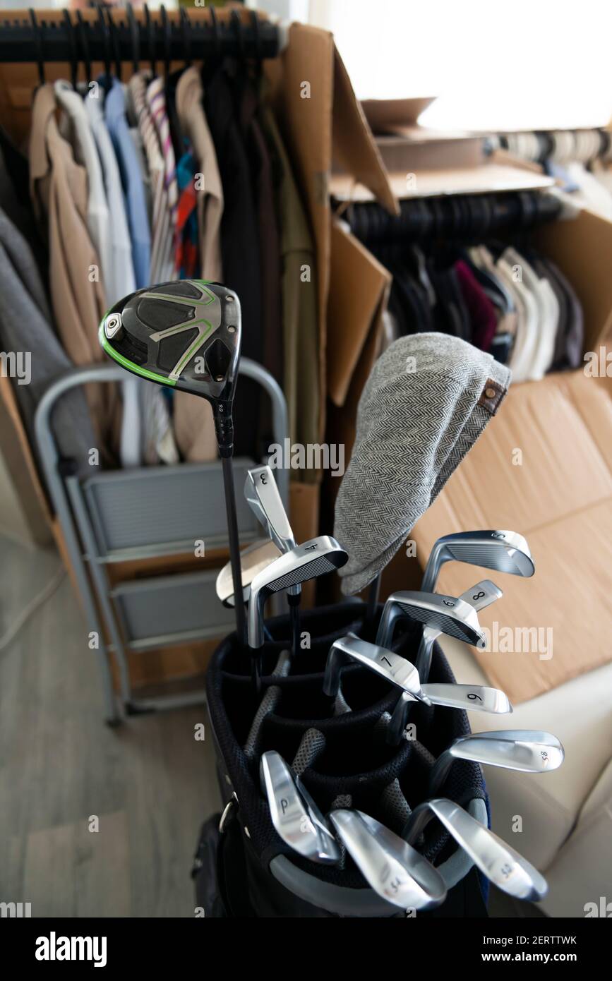 Moving House with Cardboard Boxes and Clothes and Golf Bag with Golf