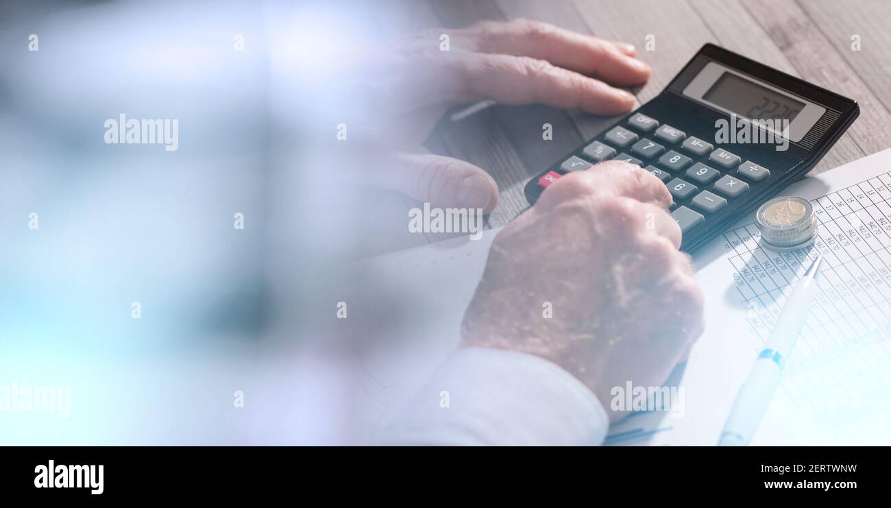 Hands of an accountant working on financial documents and using a ...