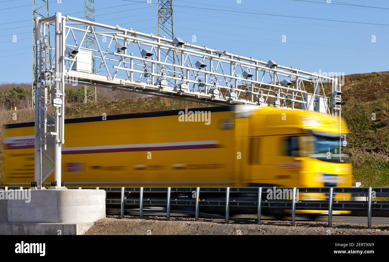Hagen, North Rhine-Westphalia, Germany - Truck drives under toll bridge on A45 freeway. Stock Photo
