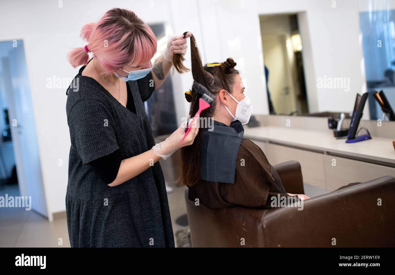 Munich, Germany. 01st Mar, 2021. A customer gets her hair dyed at Pony