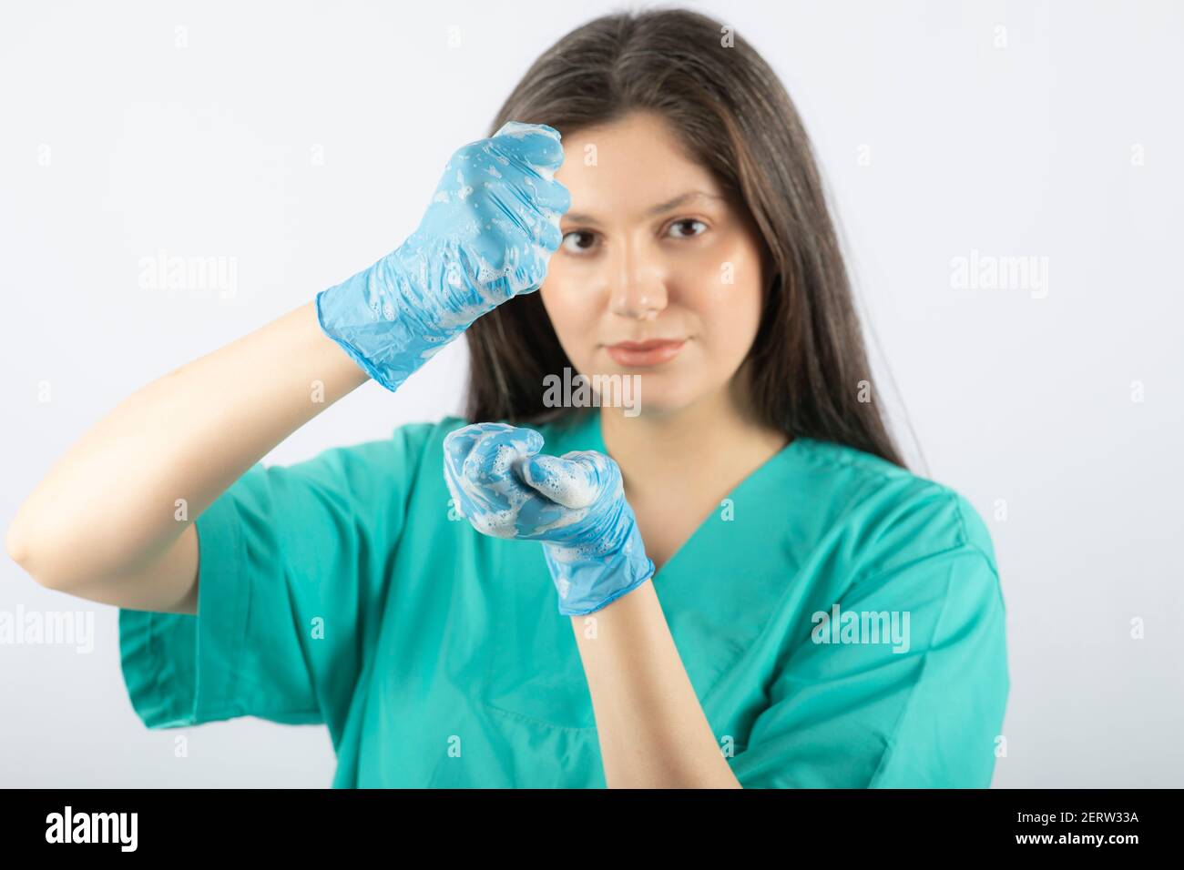 Portrait of a young nurse or doctor in green uniform posing Stock Photo