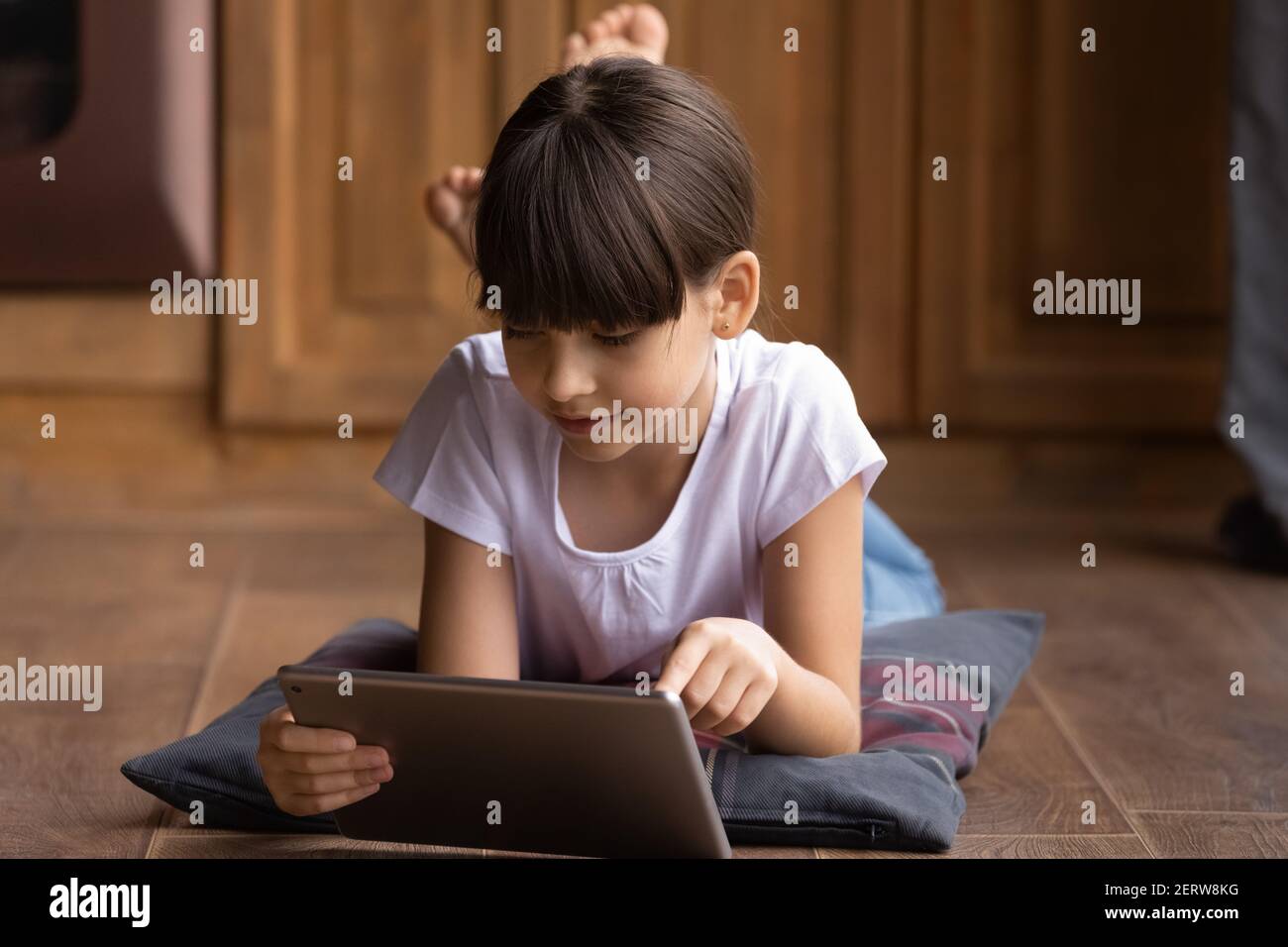 Small Latino girl use modern tablet gadget Stock Photo