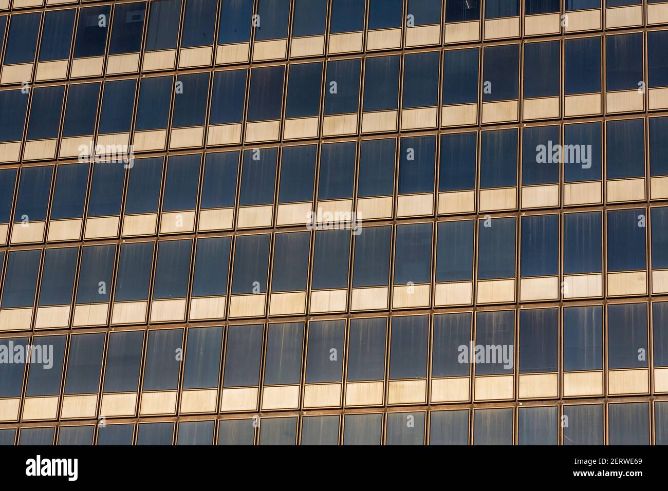 Image of a high-rise building facade with a uniform grid of windows and ...