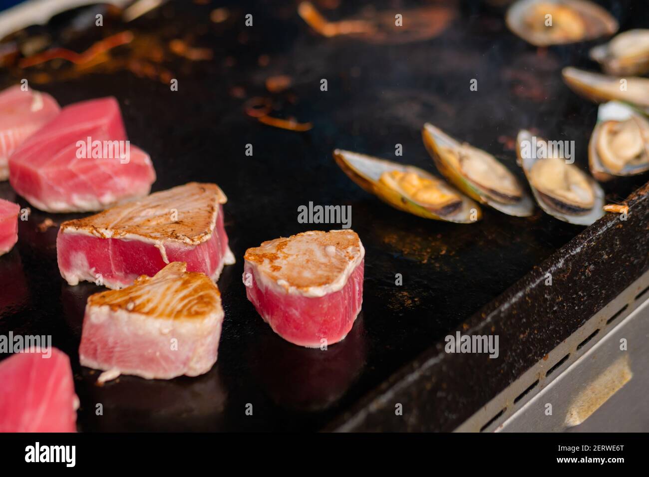 Close up process of cooking mussels, clams on grill seafood concept