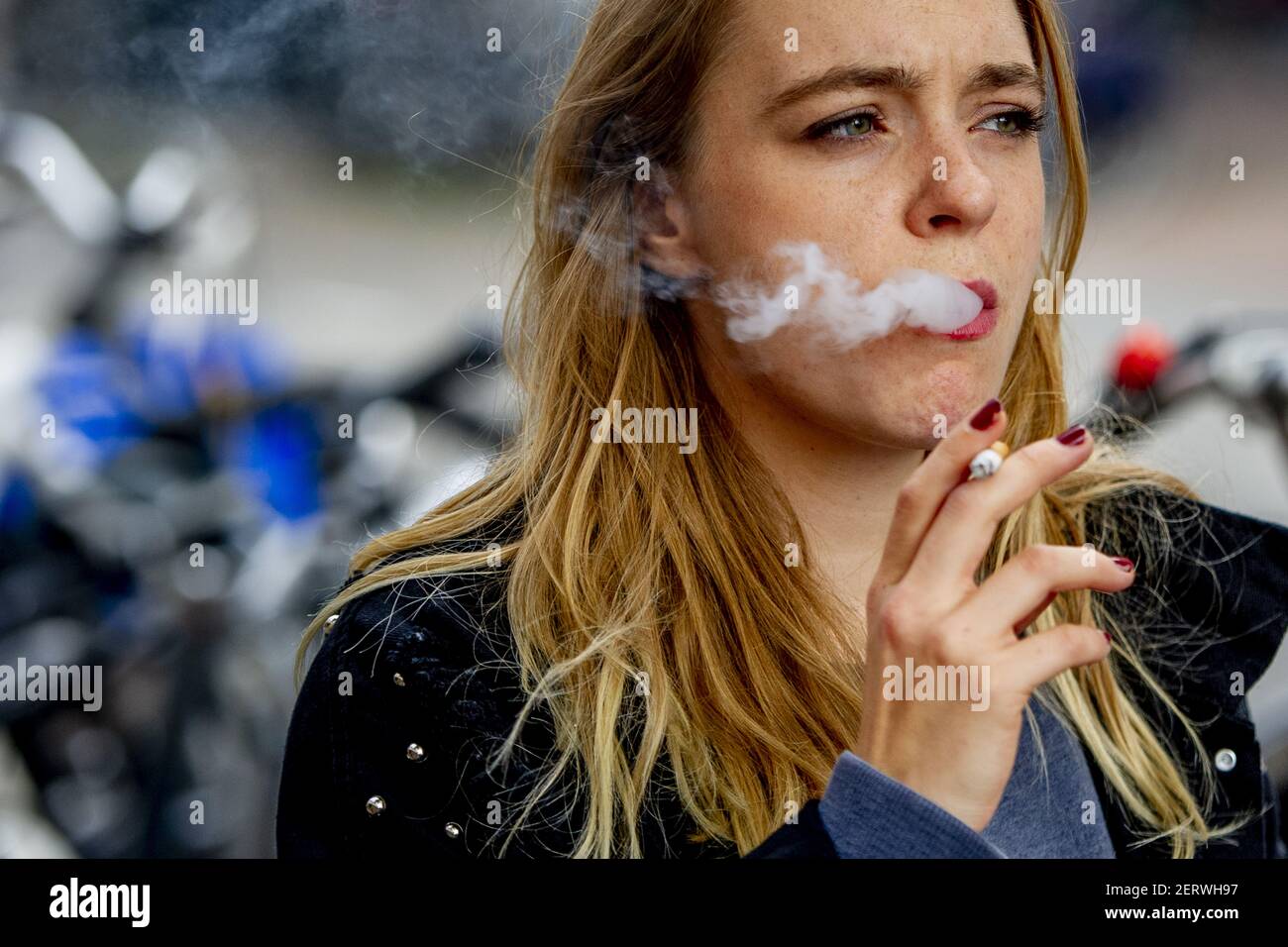 People smoking on the streets Amsterdam, Netherlands on October 18, 2018. Amsterdam  will make some smoking free streets from 2019. (Photo by Robin Utrecht/Sipa  USA Stock Photo