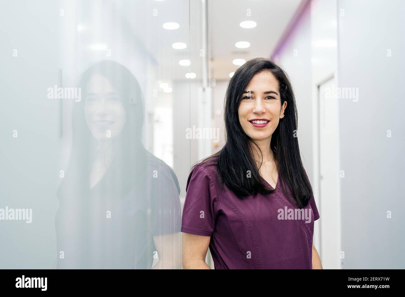 Stock photo of happy woman wearing uniform looking at camera and ...