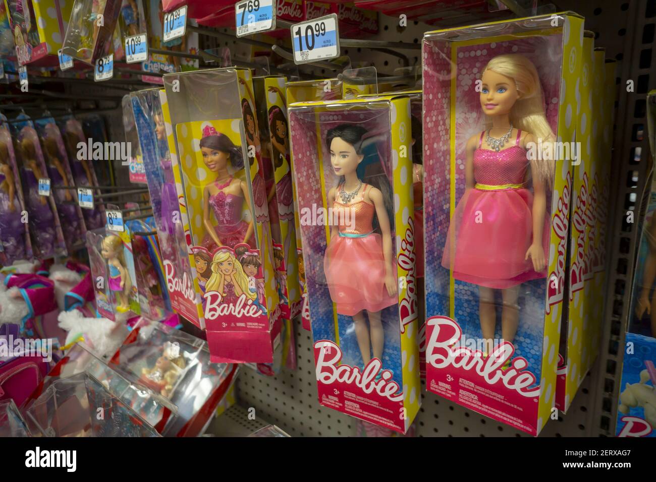 An assortment of various Mattel Barbie Dolls in a KMart store in