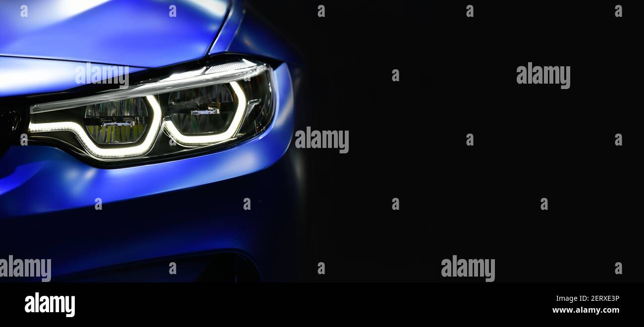 Close up detail blue modern car headlights with led technology on black background free space on right side for text. Stock Photo