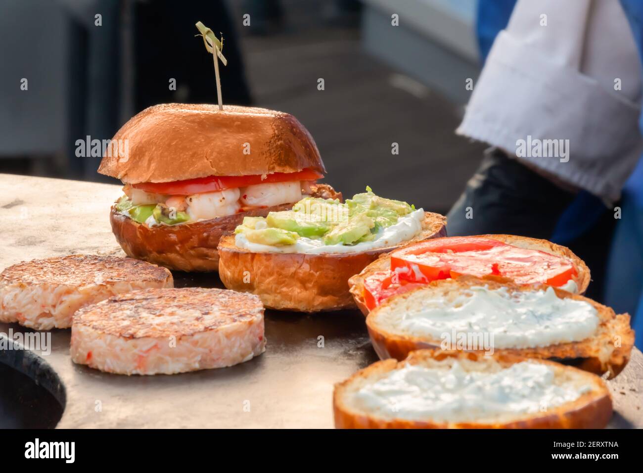 Process of preparing burgers on brazier at summer local food market