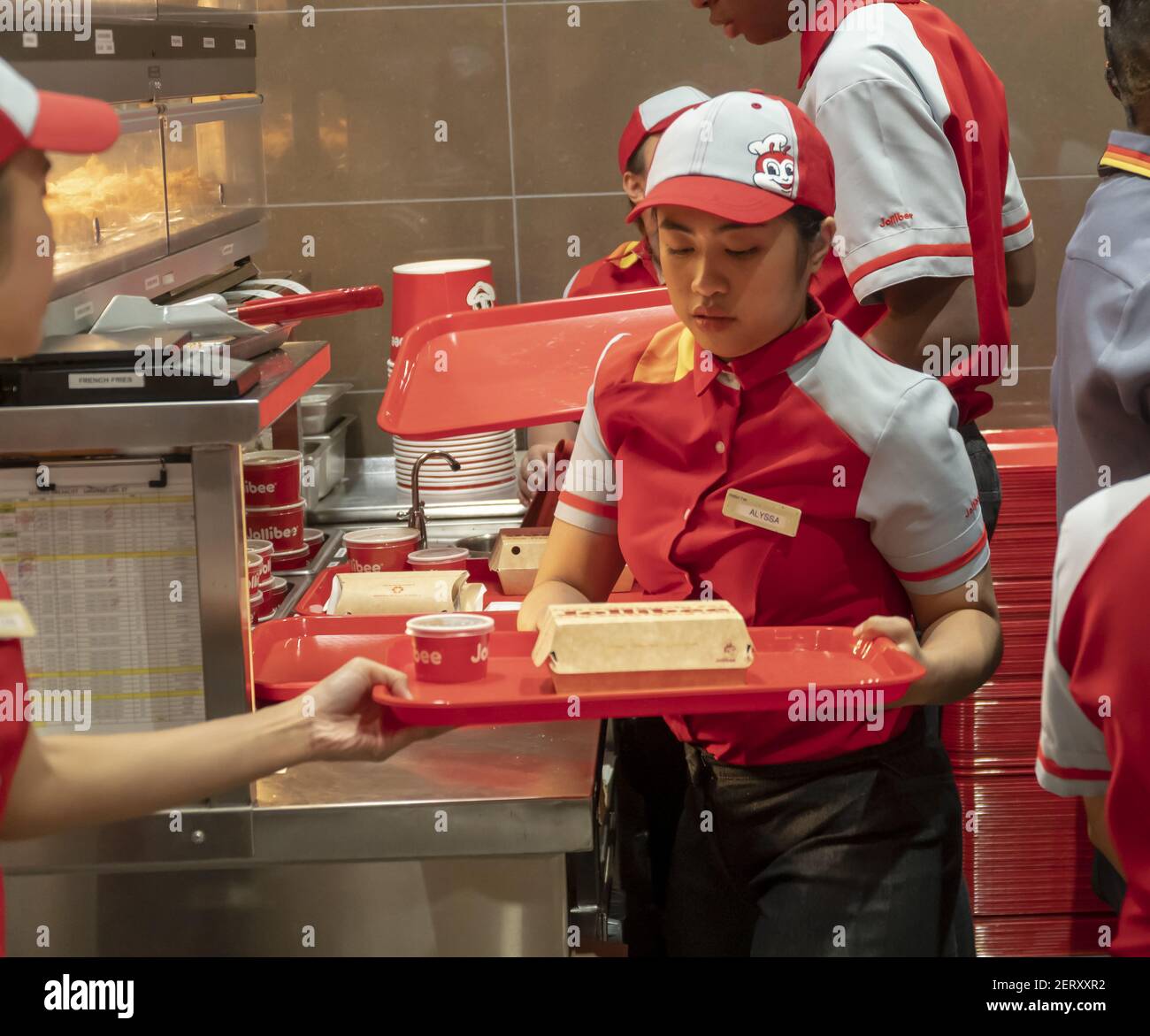 Workers hurry to prepare orders in the Jollibee fast food restaurant in Midtown Manhattan in New York on opening day Saturday, October 27, 2018 . The restaurant chain, which has been dubbed the Philippine McDonald's because of its ubiquity and popularity in the country, opened its first location to Manhattan in the Times Square area. Jollibee Foods Corp., which has plans to open hundreds of stores in the U.S. and Canada also holds a stake in the Smashburger chain. (Photo by Richard B. Levine) Stock Photo