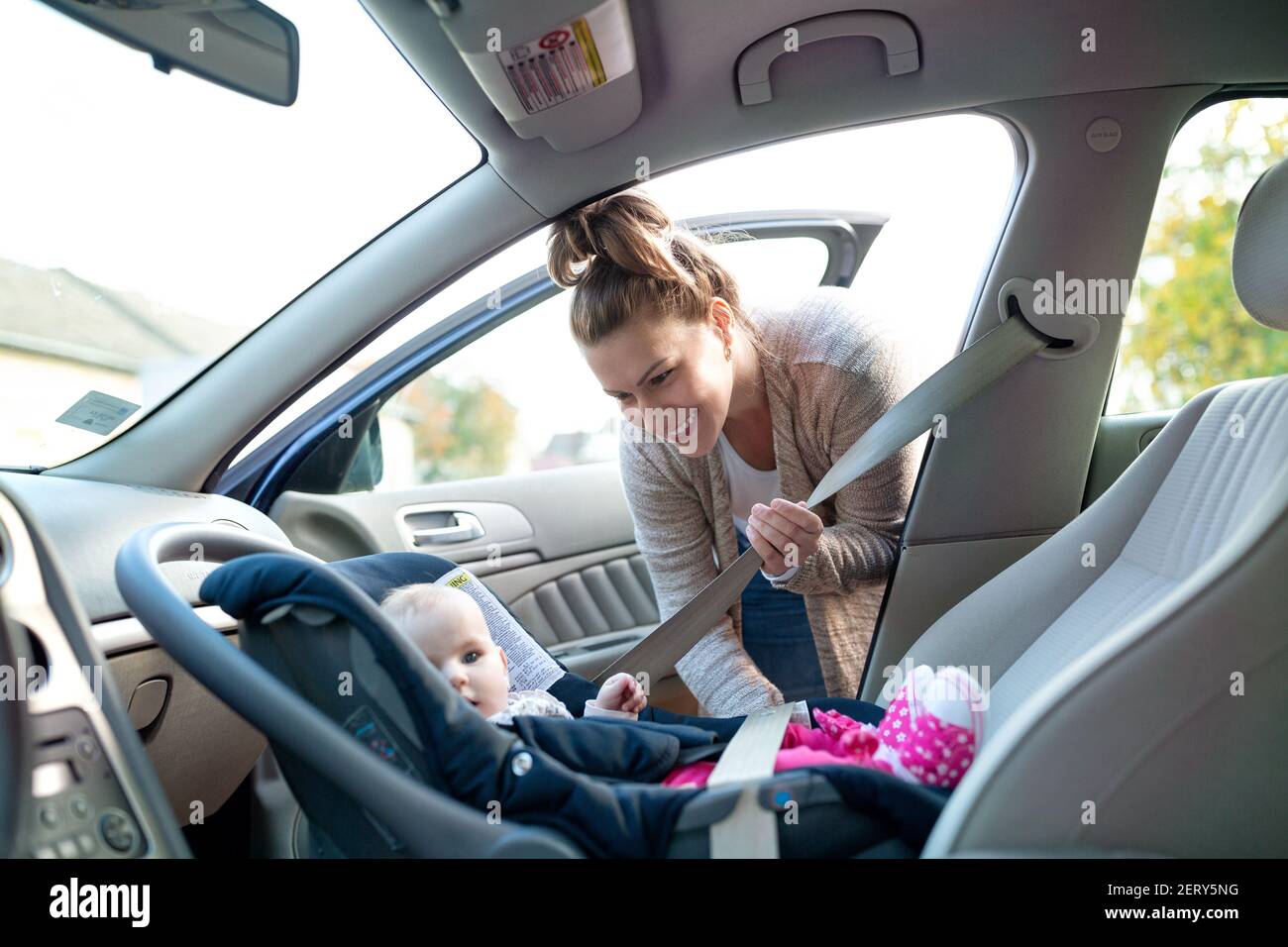 Putting on the seatbelt is important especially if a traveling companion is child of your own Stock Photo