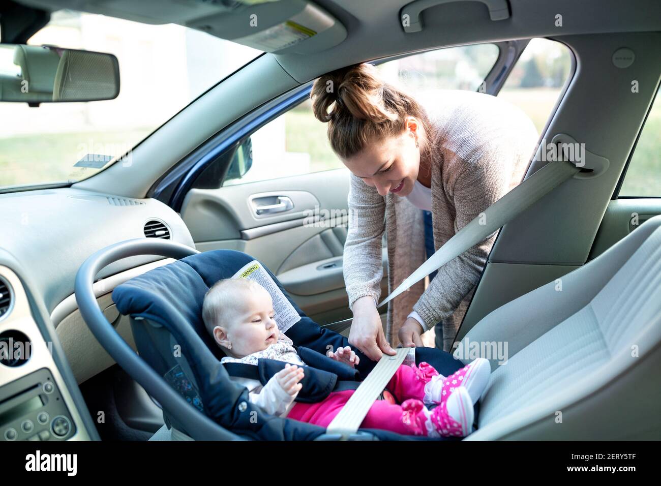 Putting on the seatbelt is important especially if a traveling companion is child of your own Stock Photo