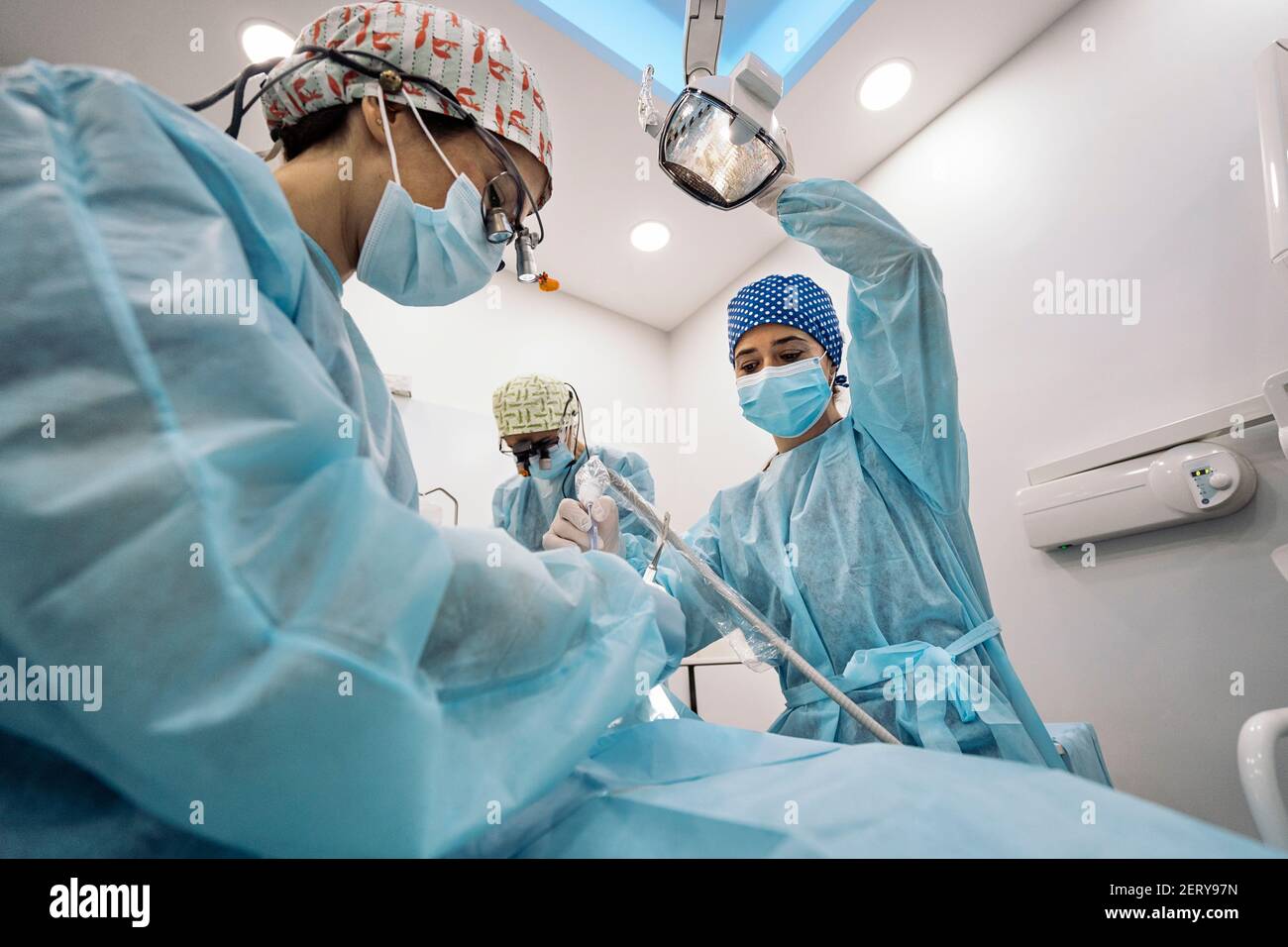 Stock photo of women team wearing face masks and hair nets working in