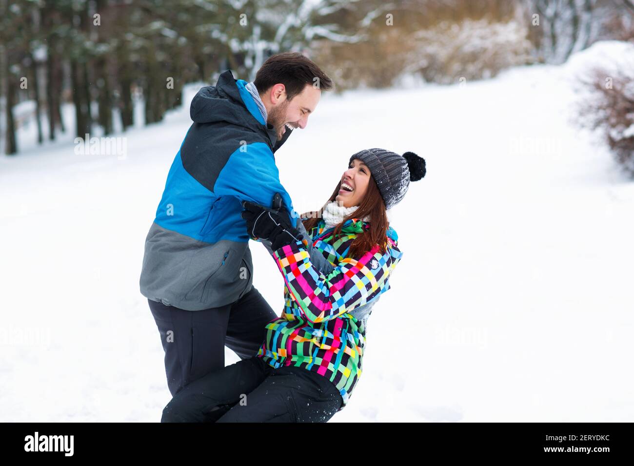 Couple having fun on snow winter day in beautiful mountain Stock Photo ...