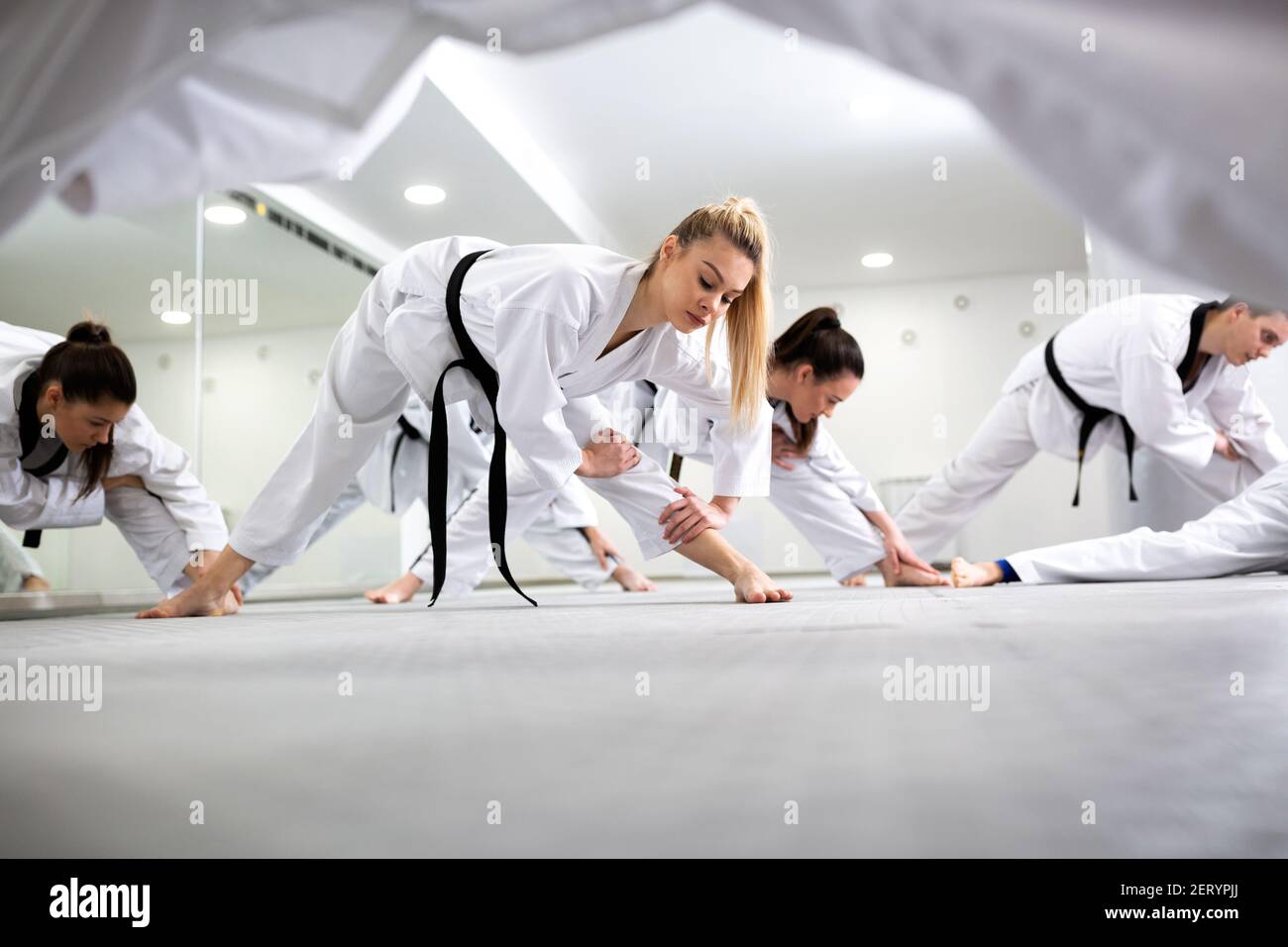 Martial art taekwondo combat fighters stretching and warming up