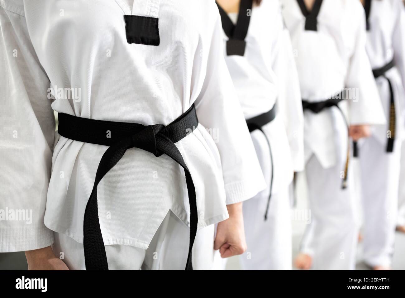 Close up of clean white martial art uniforms wearing black belts