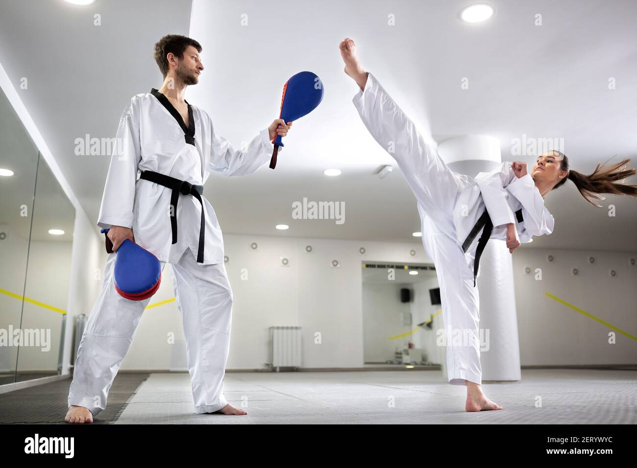 Kick pad target exercise in martial art combat training, young woman  training Stock Photo - Alamy