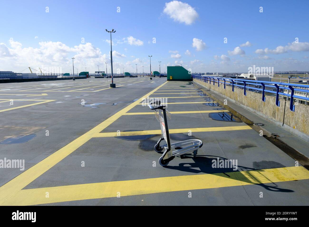 A lonely trolley is seen on an empty parking of the Zaventem airport on  February 26, 2021, in Brussels, Belgium. The number of daily deaths from  the coronavirus is still in sharp