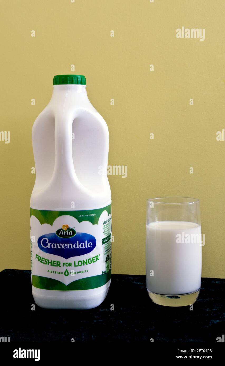 Plastic Container & Glass of Arla Cravendale Filtered Milk, UK Stock Photo