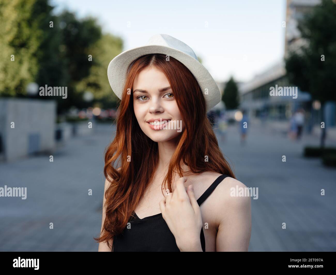 Beautiful woman in black dress walks back hi-res stock photography and ...