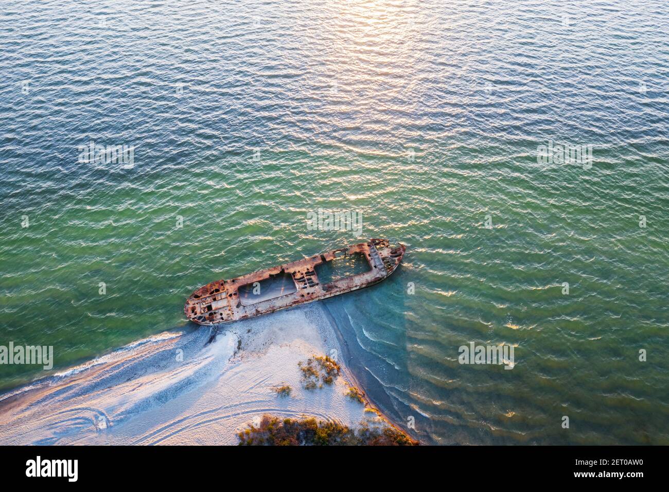 Old shipwreck reinforced concrete barge abandoned stand on beach on the coast of Black sea in Ukraine Stock Photo