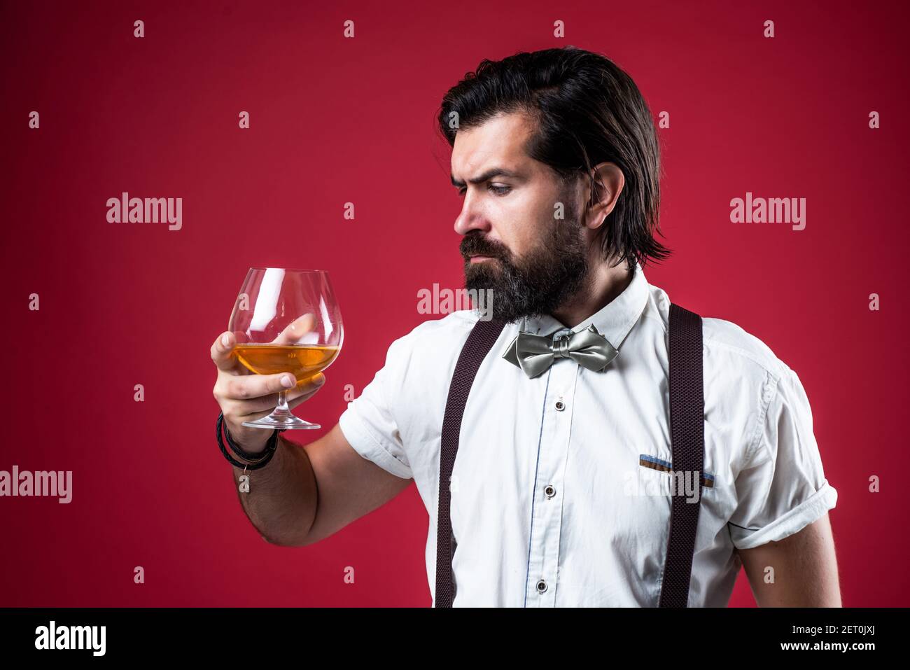handsome guy hipster with moustache and beard drink kignac, barkeeper. Stock Photo