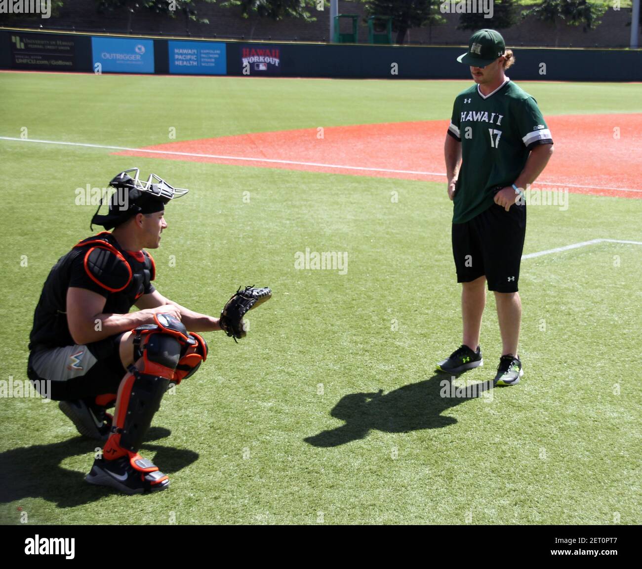 November 4, 2018 - Miami Marlins J.T. Realmuto shares some knowledge with  Hawaii Rainbow Warriors catcher Tyler Murray during a warm up workout  session at Les Murakami Stadium on the campus of