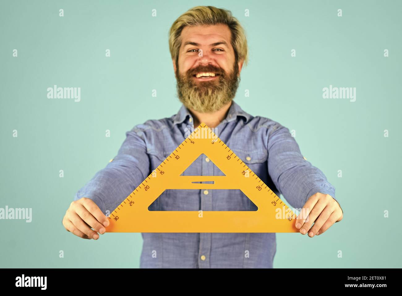 mathematics and people concept. bearded tutor man with ruler. draw and ...
