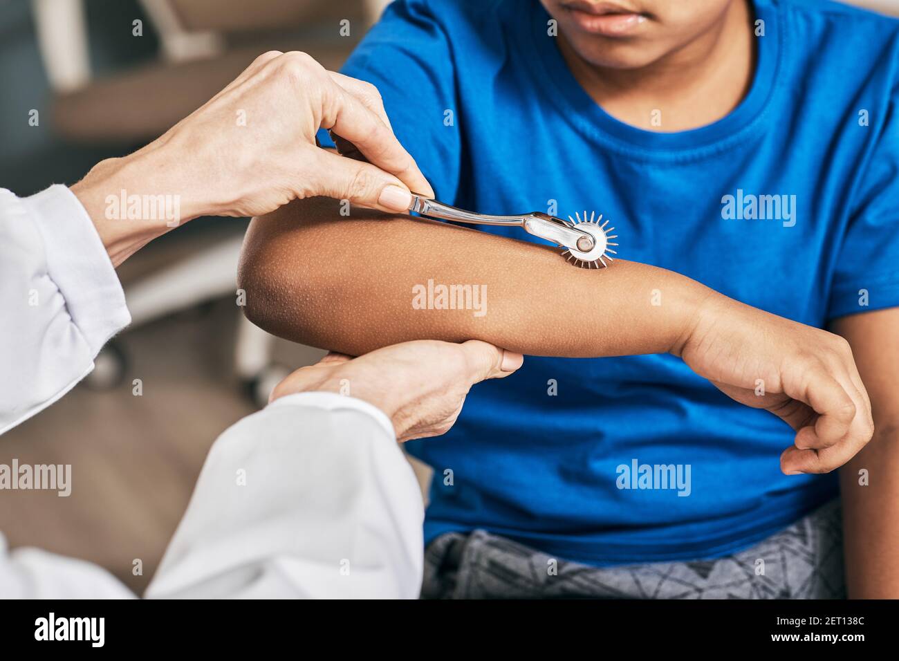 Close-up of little boy hand check-up using neurological needle wheel in a neurological clinic Stock Photo