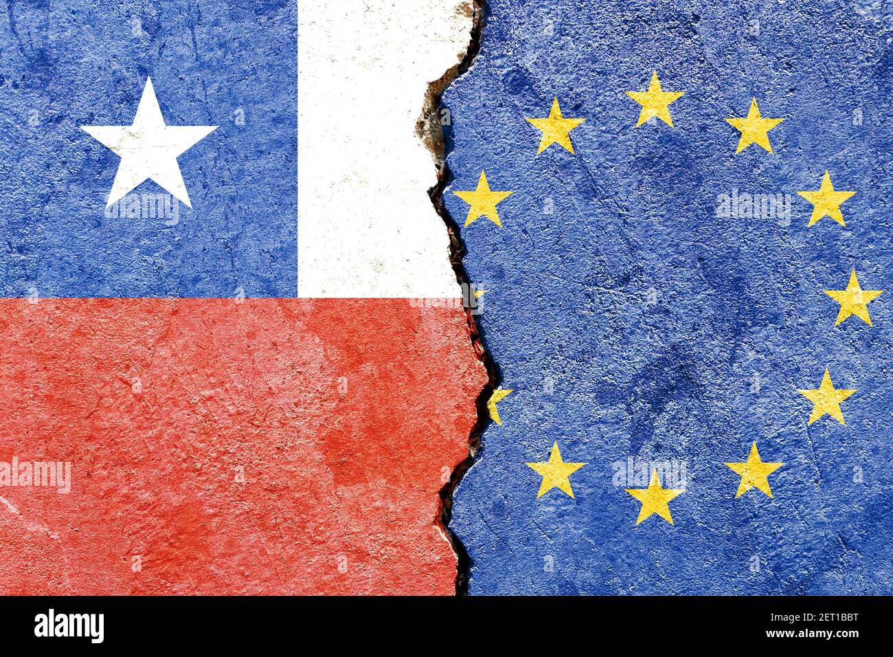 A top view of a cracked stone painted with the flags of Chile and E ...