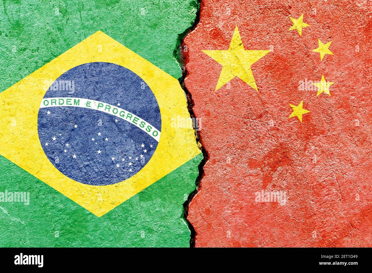 A top view of a cracked stone painted with the flags of Brazil and Chi ...