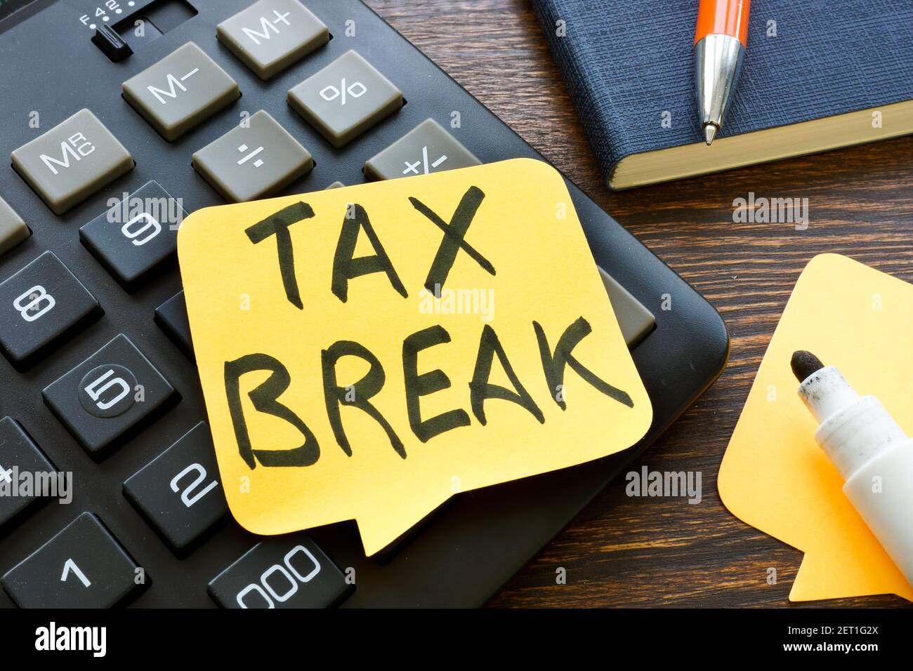 Tax break memo on the calculator and pen. Stock Photo